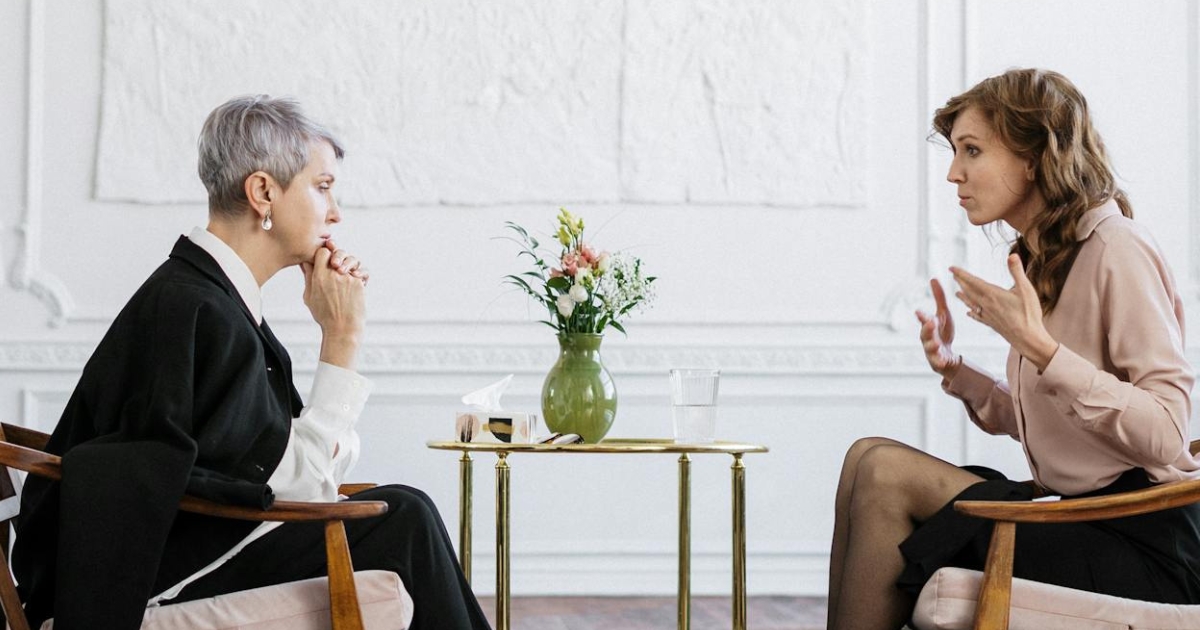 Counseling psychologist offering professional guidance to individuals in a calm office setting.