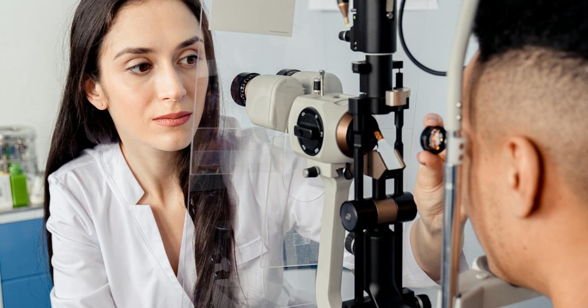 Optometrist conducting a comprehensive eye examination for a patient in a modern clinic.